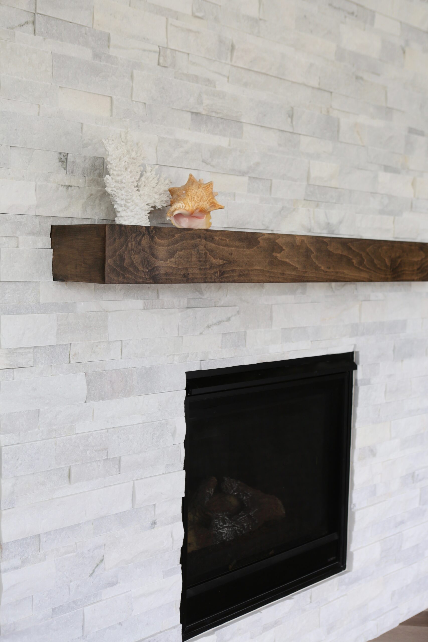 Stone fireplace with wooden mantel and recessed firebox